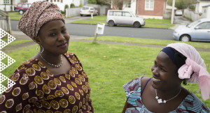 Two woman wearing headscarves smiling